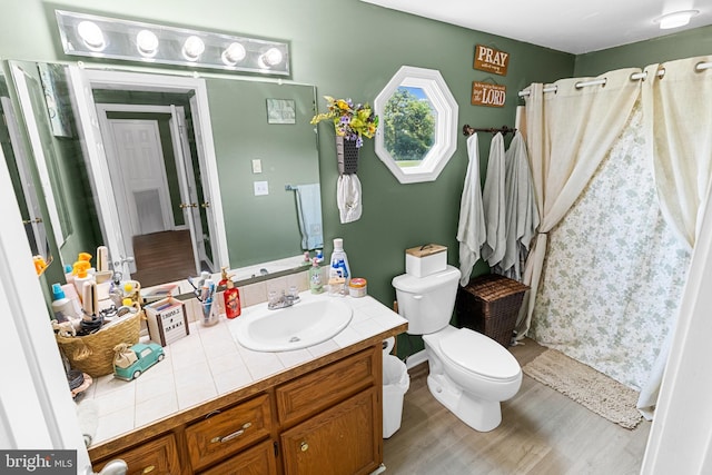 bathroom featuring hardwood / wood-style floors, vanity, and toilet