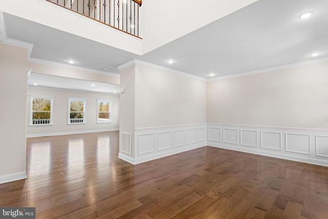 unfurnished room featuring dark hardwood / wood-style flooring and crown molding