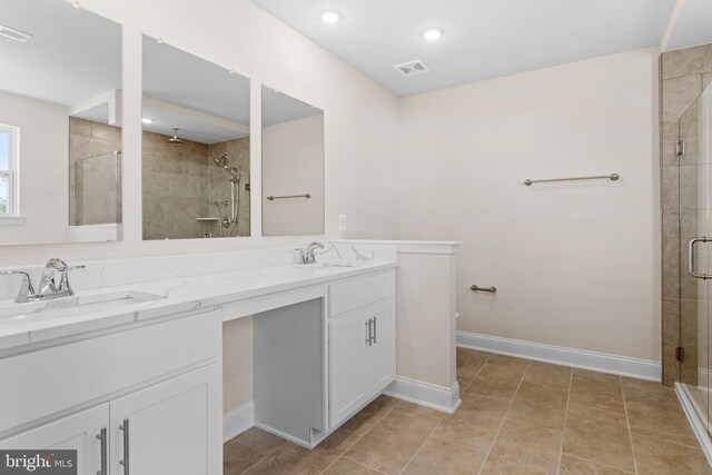 bathroom with vanity, tile patterned floors, and walk in shower