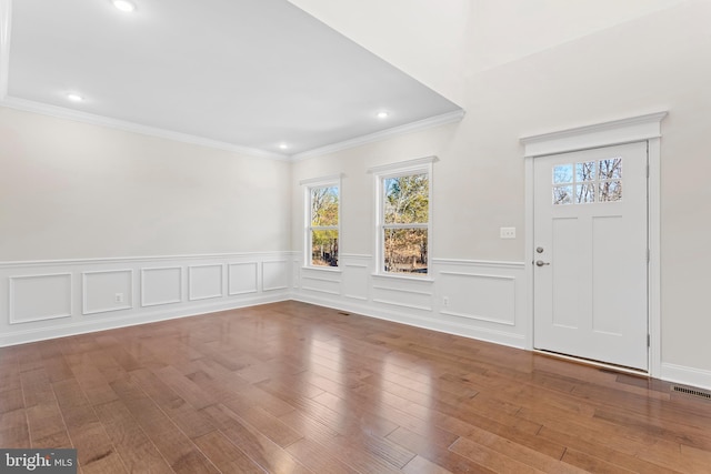 entrance foyer featuring hardwood / wood-style flooring and ornamental molding