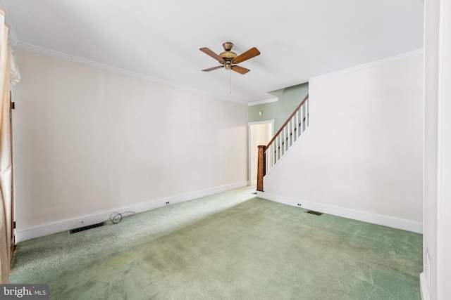 spare room with ceiling fan, carpet floors, and ornamental molding