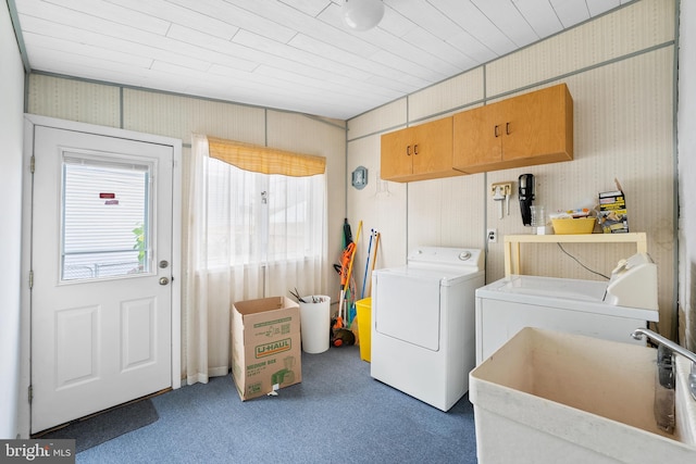 laundry room with dark carpet, wood ceiling, washer and dryer, and sink