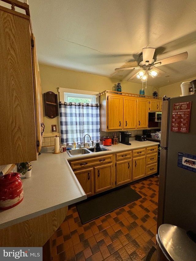 kitchen with stainless steel fridge, ceiling fan, and sink