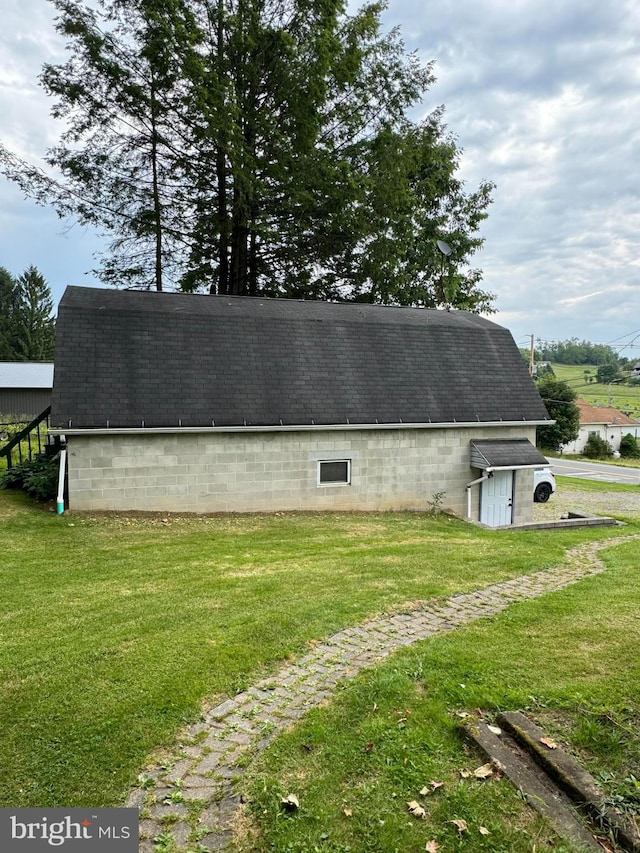 view of outbuilding featuring a yard