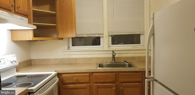 kitchen featuring white appliances and sink