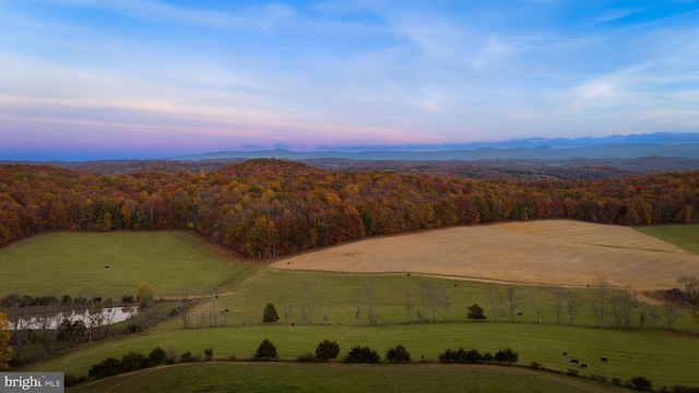 aerial view at dusk featuring a mountain view