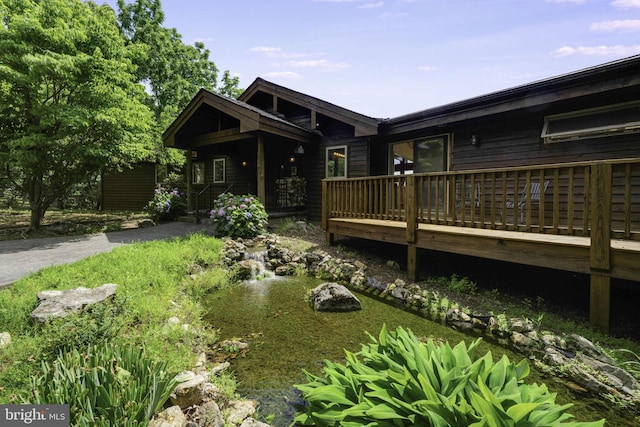 back of house featuring a wooden deck