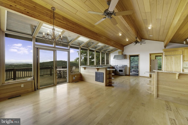 interior space with lofted ceiling with beams, plenty of natural light, light hardwood / wood-style floors, and wooden ceiling