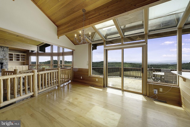 sunroom featuring wood ceiling, plenty of natural light, lofted ceiling with beams, and an inviting chandelier