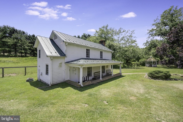 back of house featuring a lawn