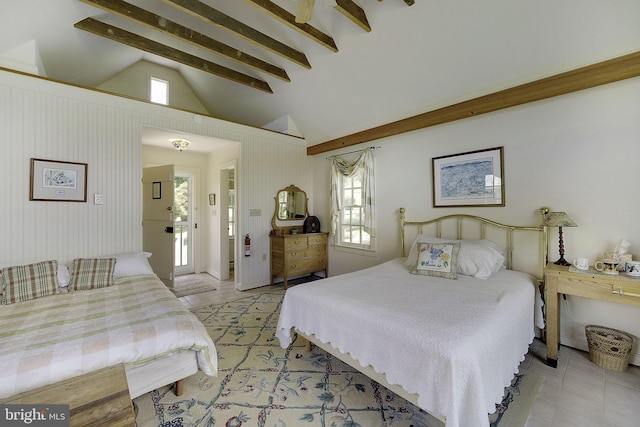 bedroom featuring multiple windows, light tile patterned floors, and vaulted ceiling with beams