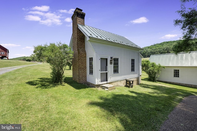 view of side of home featuring a yard