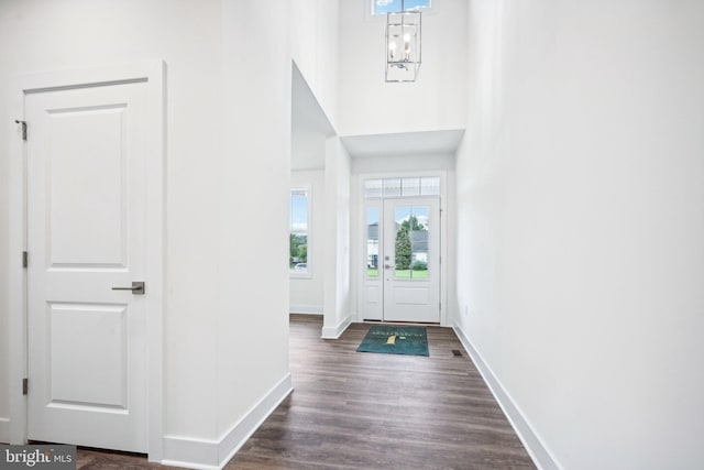 foyer entrance featuring dark hardwood / wood-style floors and an inviting chandelier