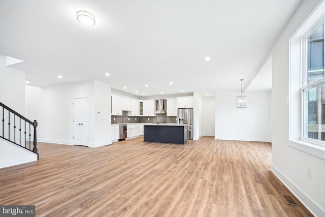 unfurnished living room featuring light wood-type flooring