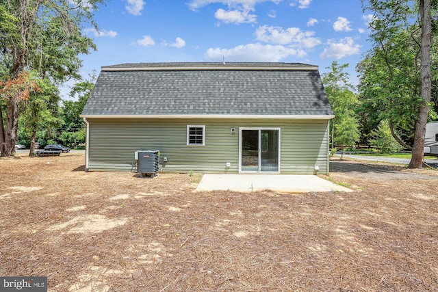 rear view of property featuring a patio and central air condition unit