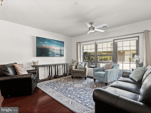 living area featuring a ceiling fan and wood finished floors