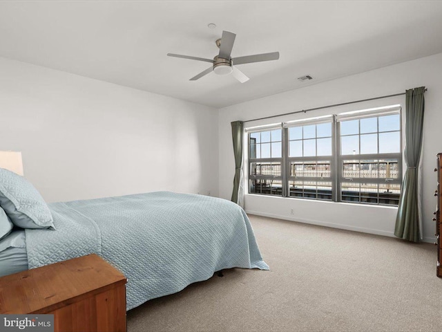 bedroom featuring baseboards, visible vents, carpet floors, and ceiling fan