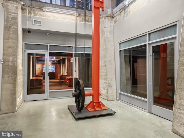 property entrance featuring visible vents and a patio