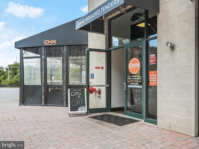 entrance to property with concrete block siding