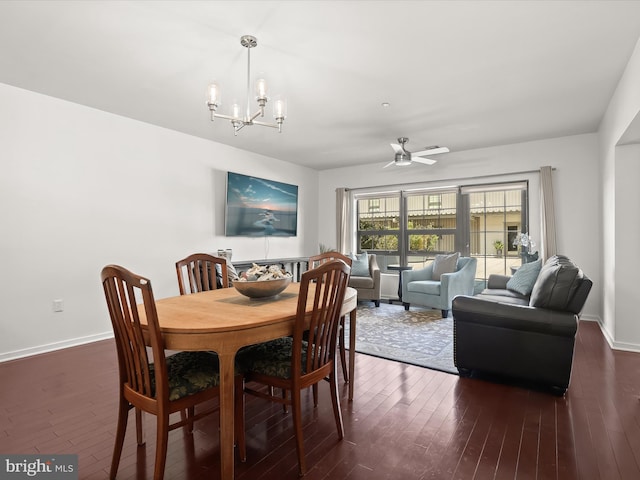 dining room with baseboards, dark wood-style flooring, and ceiling fan with notable chandelier