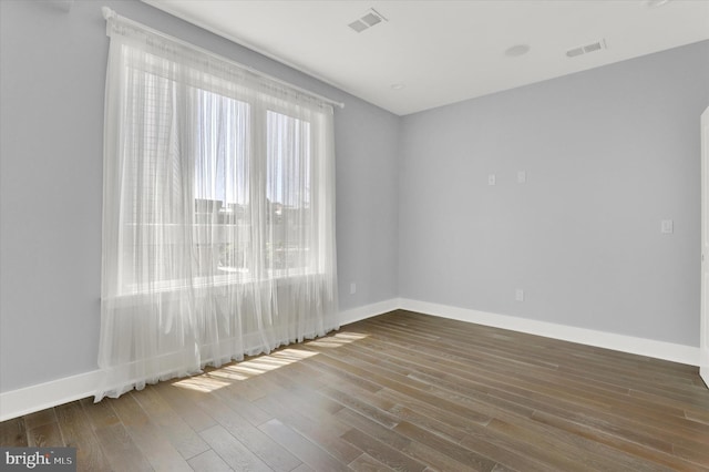 unfurnished room featuring dark hardwood / wood-style floors