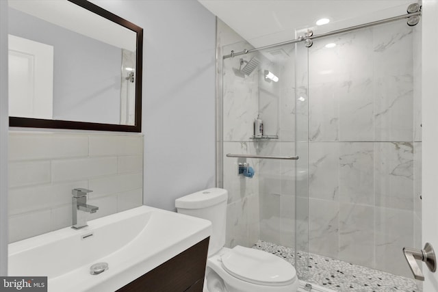 bathroom with walk in shower, vanity, and toilet