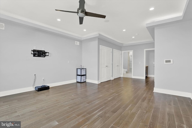 unfurnished living room featuring ceiling fan and hardwood / wood-style flooring