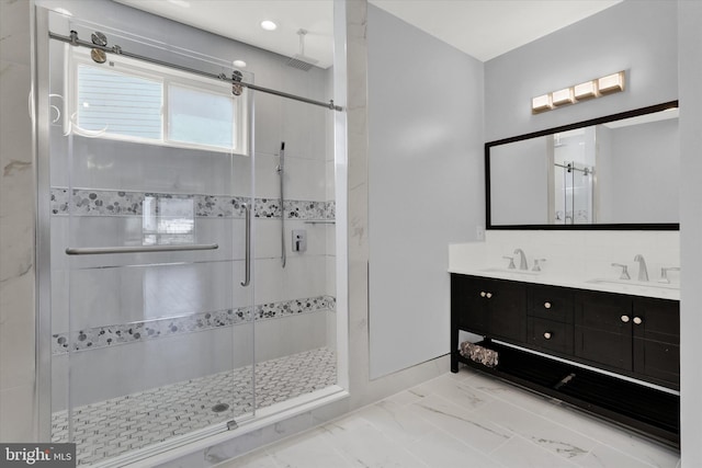 bathroom featuring vanity and a shower with door