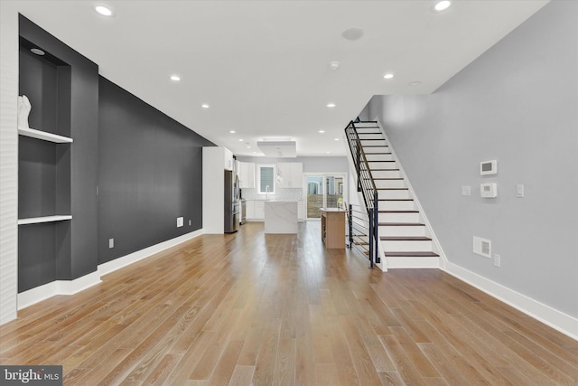 unfurnished living room featuring light hardwood / wood-style flooring