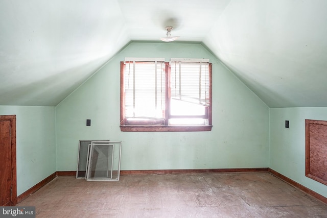 additional living space with vaulted ceiling