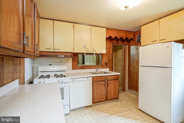 kitchen with decorative backsplash, sink, and white appliances