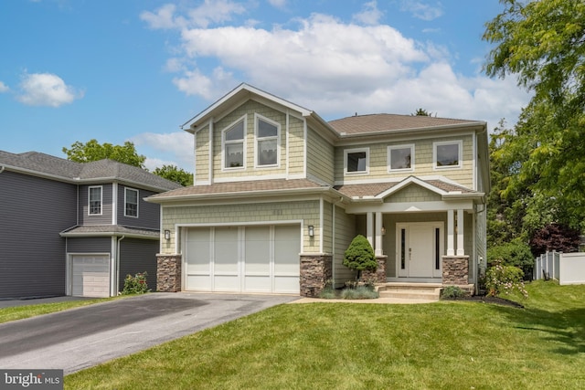 view of front of property featuring a garage and a front lawn