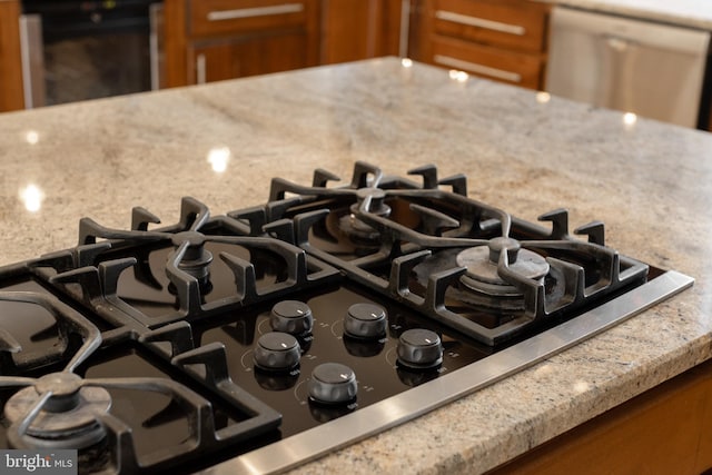 room details featuring stainless steel appliances and light stone counters