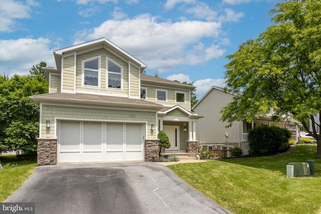 view of front of property with a garage and a front lawn