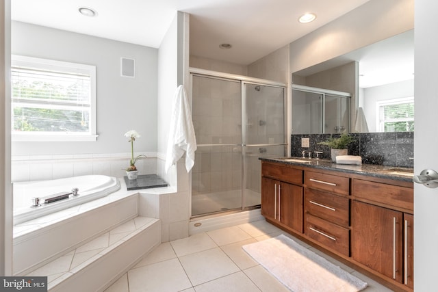 bathroom with tile patterned floors, plus walk in shower, and vanity