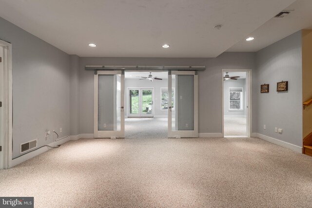 empty room with light colored carpet and ceiling fan