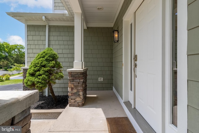 view of exterior entry with covered porch