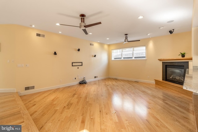 unfurnished living room with light hardwood / wood-style flooring and ceiling fan