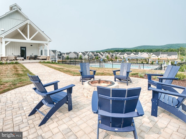 view of patio / terrace with a fenced in pool and an outdoor fire pit