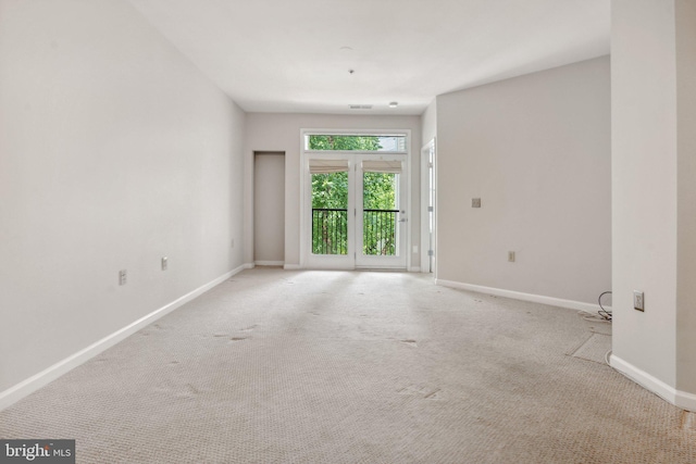 unfurnished room featuring light colored carpet