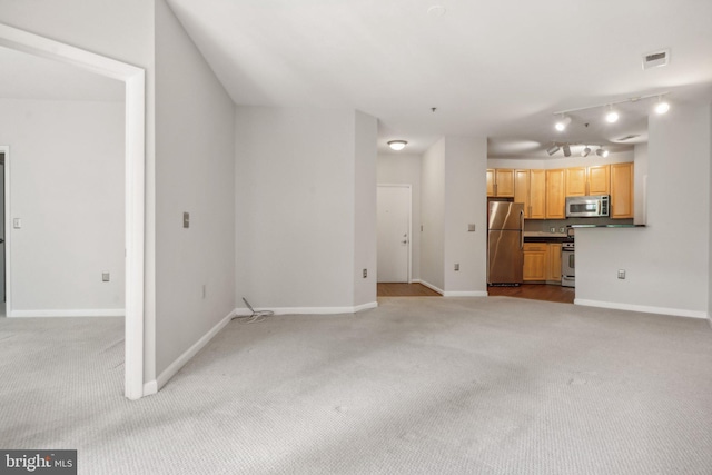 unfurnished living room with light colored carpet