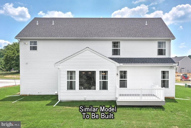 back of property featuring a deck and a yard