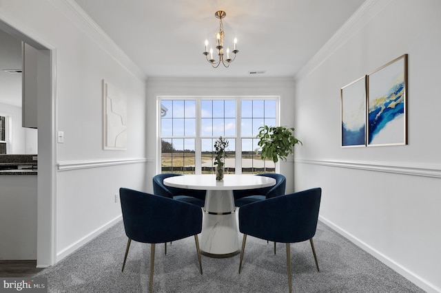 carpeted dining room featuring ornamental molding and an inviting chandelier