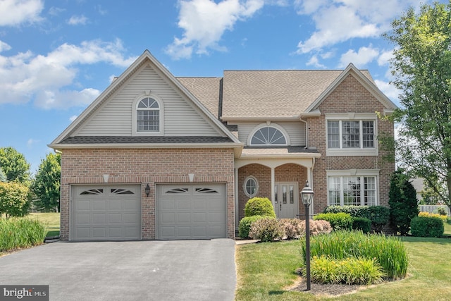 view of front facade with a front yard and a garage