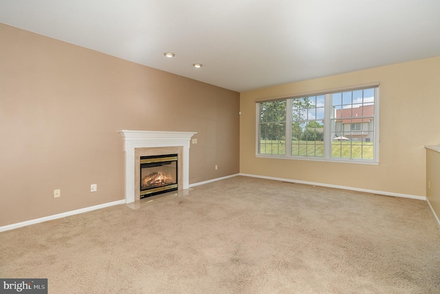 unfurnished living room featuring light colored carpet and a premium fireplace