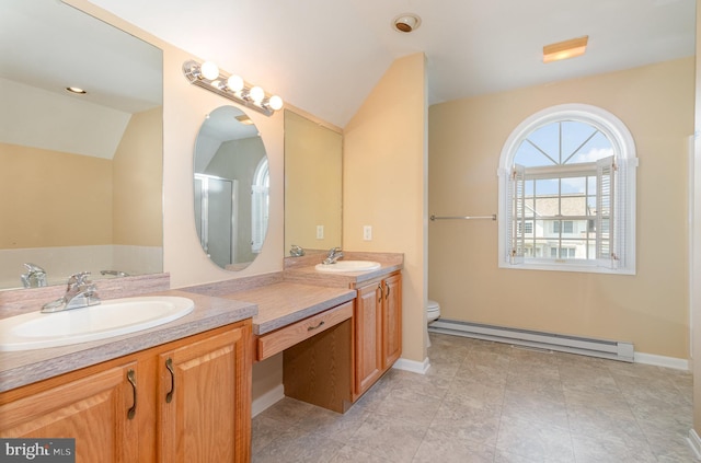 bathroom with vanity, lofted ceiling, a baseboard heating unit, tile patterned flooring, and toilet