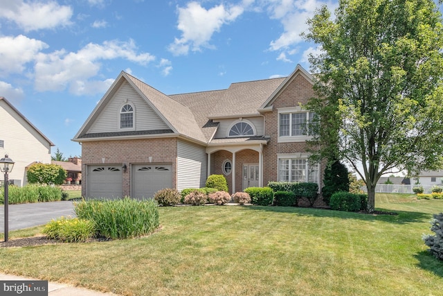 view of front facade with a garage and a front yard