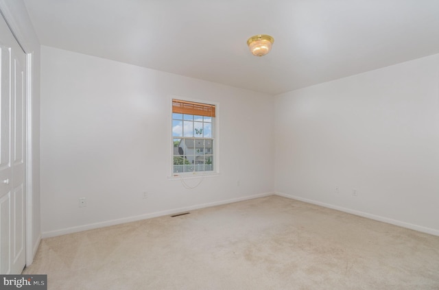 empty room with light colored carpet