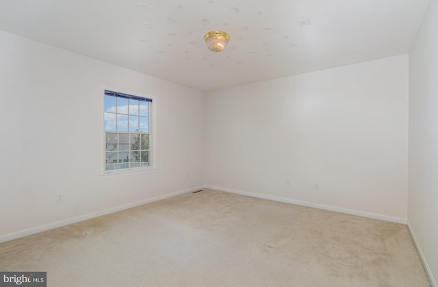 empty room featuring light colored carpet