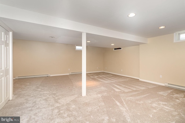 basement featuring light carpet and a baseboard radiator